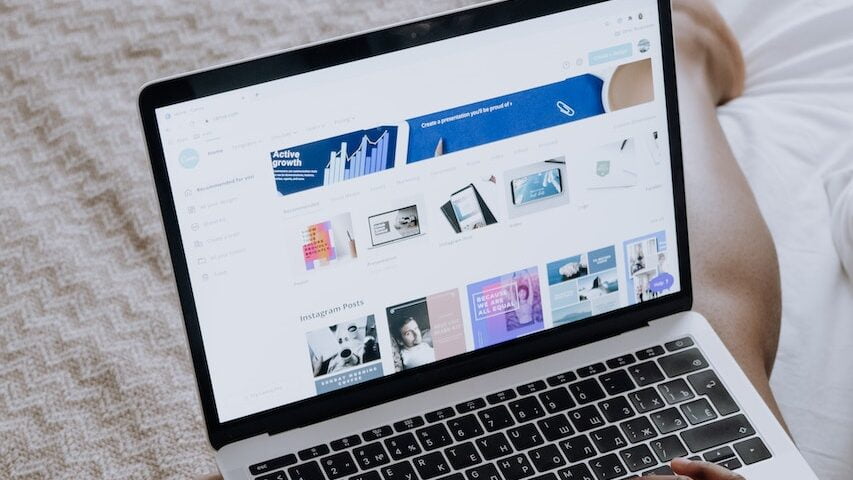 Person Using Macbook Pro on Brown Textile