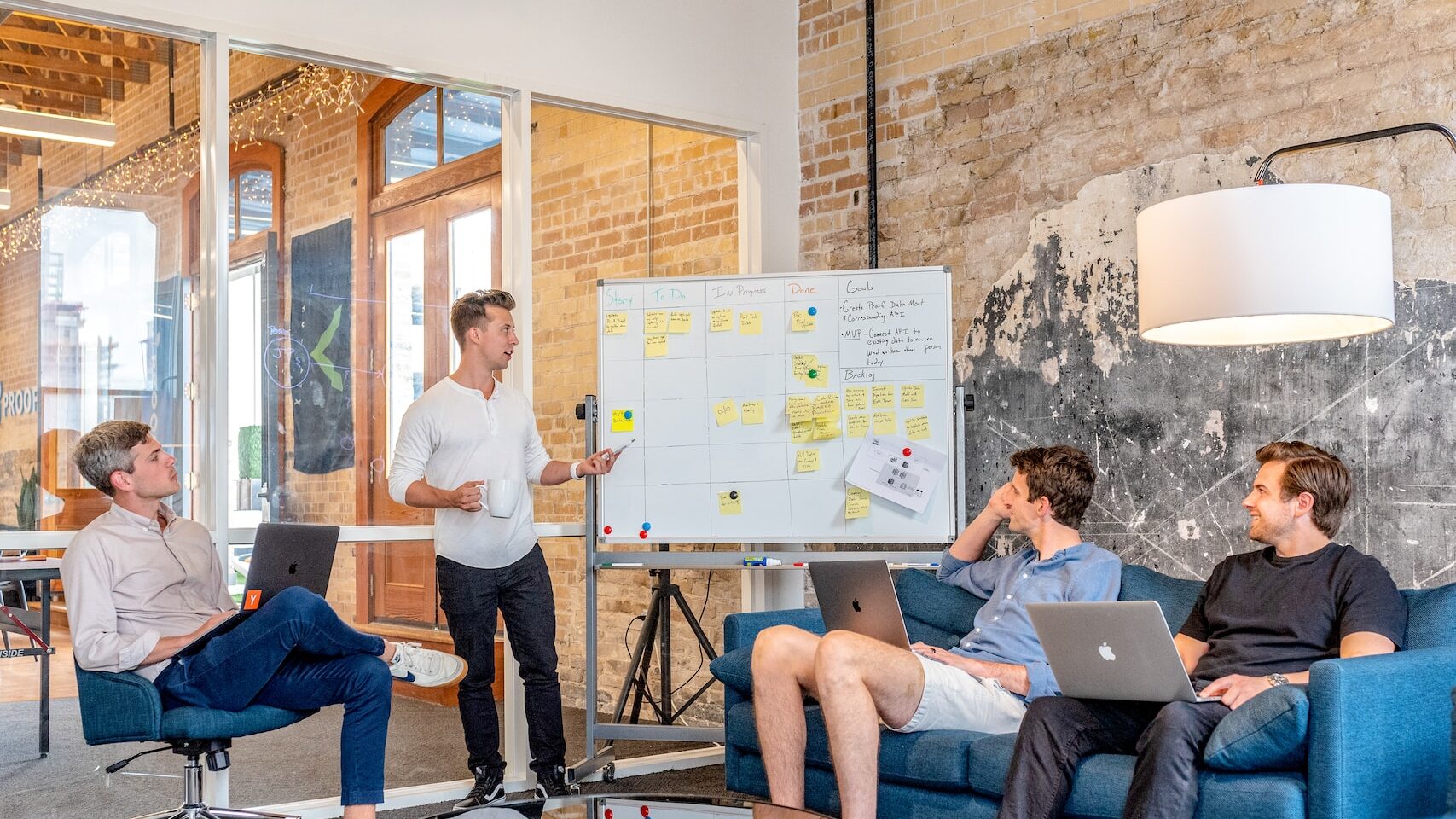 Digital Nomad Communities: Navigating the Best Hotspots of the Technomadic World 2023 3 three men sitting while using laptops and watching man beside whiteboard in their digital nomad communities